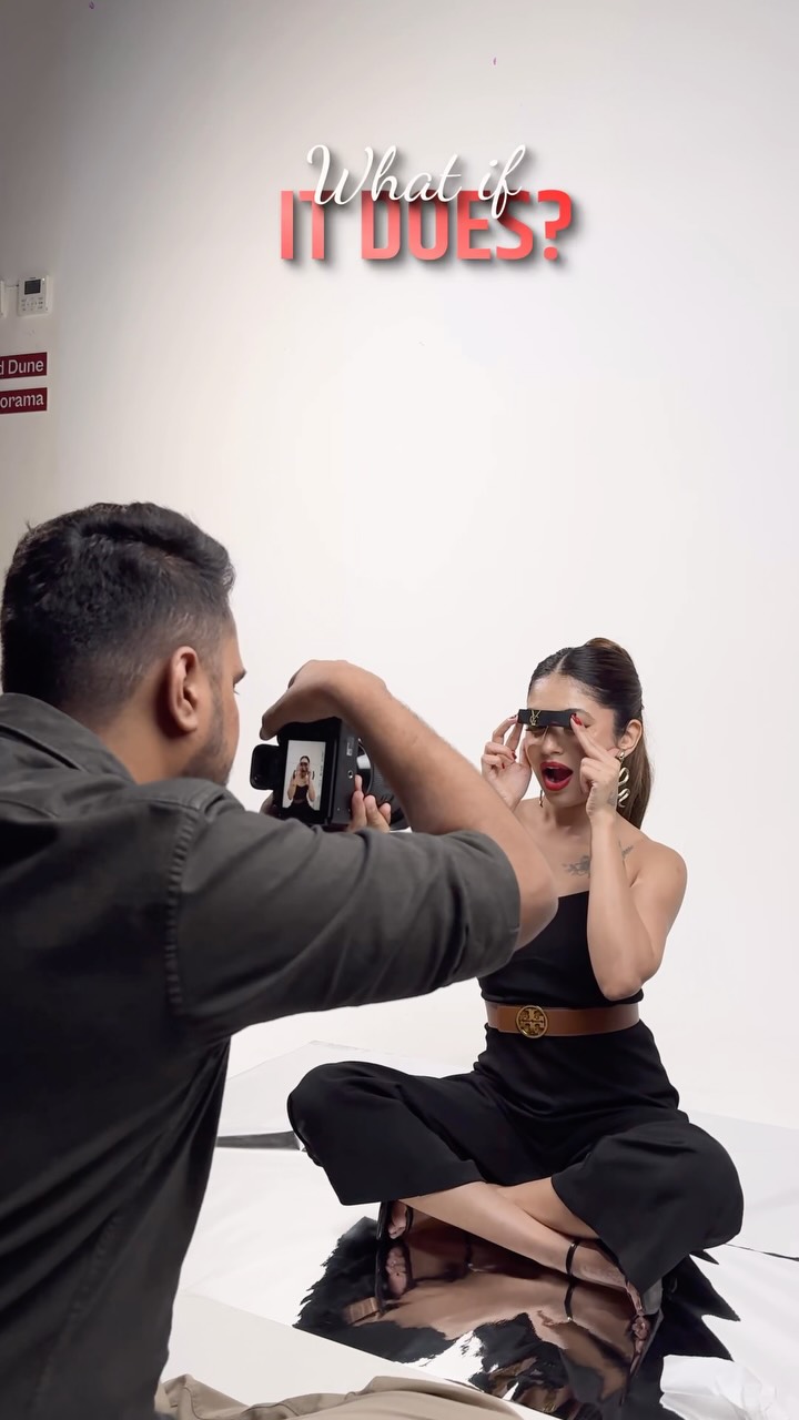 A Wabi Sabi Studio photographer shooting a model seated on a white cyclorama